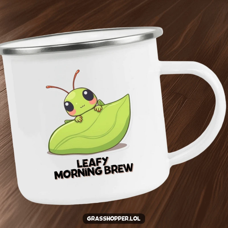 Funny kawaii grasshopper peeking from behind a large leaf, a cute and sturdy enamel camping mug for your travels.