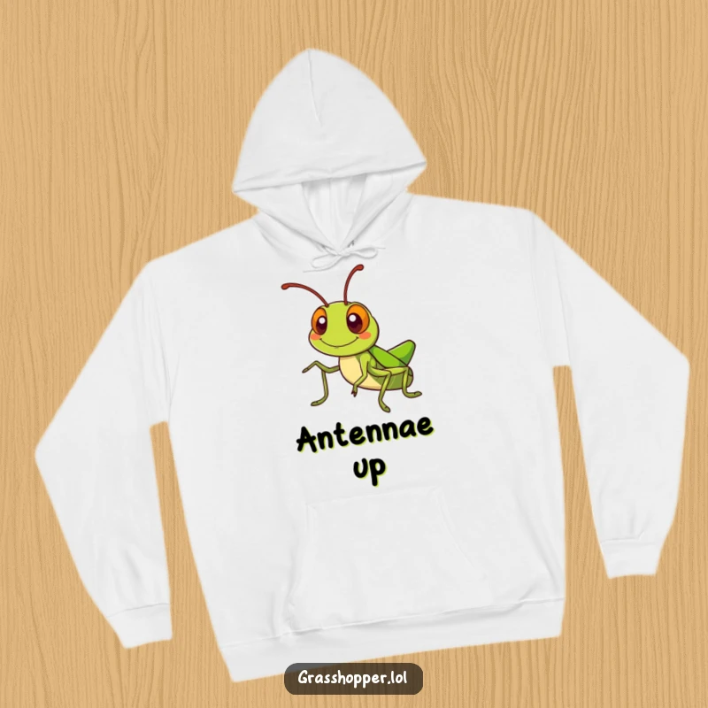 Kawaii grasshopper hoodie showing a cute grasshopper with a silly grin, waving its antennae, perfect for cozy fun.